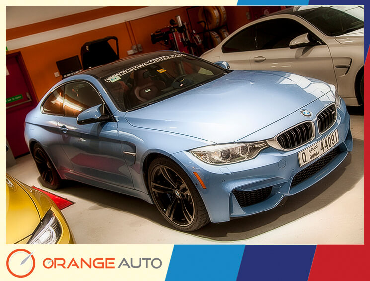 Blue BMW in a garage