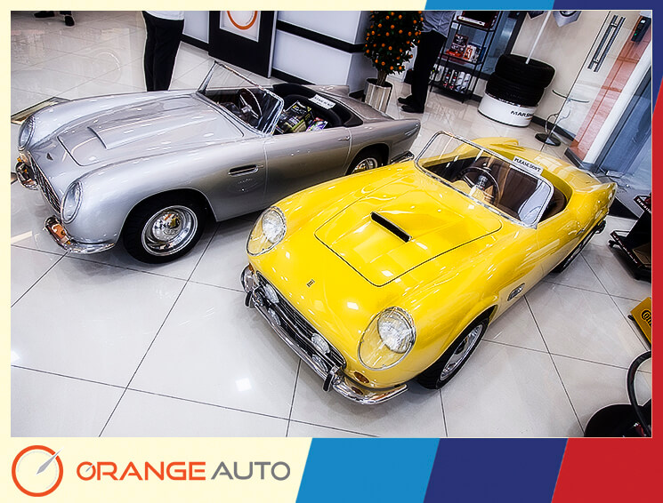 Yellow and silver retro cars in a garage